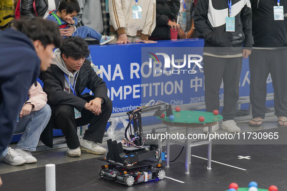 Visitors watch a robot perform at the China Robot Competition in Xi'an, China, on November 2, 2024. 