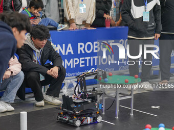 Visitors watch a robot perform at the China Robot Competition in Xi'an, China, on November 2, 2024. (