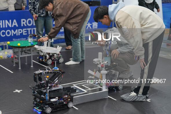 Visitors watch a robot perform at the China Robot Competition in Xi'an, China, on November 2, 2024. 