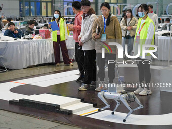 Visitors watch a robot perform at the China Robot Competition in Xi'an, China, on November 2, 2024. (