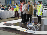 Visitors watch a robot perform at the China Robot Competition in Xi'an, China, on November 2, 2024. (