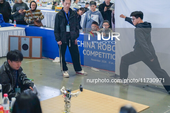 Visitors watch a robot perform at the China Robot Competition in Xi'an, China, on November 2, 2024. 