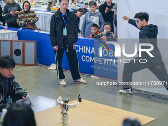 Visitors watch a robot perform at the China Robot Competition in Xi'an, China, on November 2, 2024. (