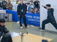 Visitors watch a robot perform at the China Robot Competition in Xi'an, China, on November 2, 2024. (