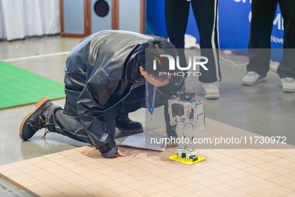 Visitors watch a robot perform at the China Robot Competition in Xi'an, China, on November 2, 2024. 