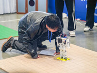 Visitors watch a robot perform at the China Robot Competition in Xi'an, China, on November 2, 2024. (