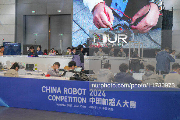 Visitors watch a robot perform at the China Robot Competition in Xi'an, China, on November 2, 2024. 