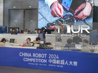 Visitors watch a robot perform at the China Robot Competition in Xi'an, China, on November 2, 2024. (