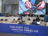 Visitors watch a robot perform at the China Robot Competition in Xi'an, China, on November 2, 2024. (