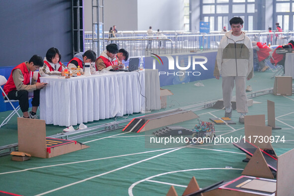 Visitors watch a robot perform at the China Robot Competition in Xi'an, China, on November 2, 2024. 