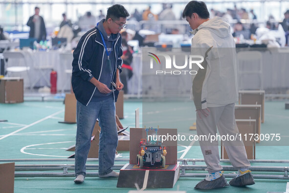 Visitors watch a robot perform at the China Robot Competition in Xi'an, China, on November 2, 2024. 