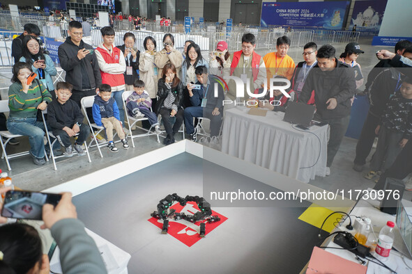 Visitors watch a robot perform at the China Robot Competition in Xi'an, China, on November 2, 2024. 