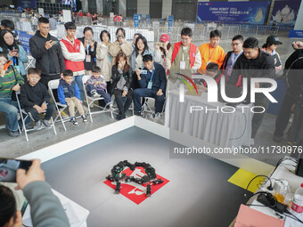 Visitors watch a robot perform at the China Robot Competition in Xi'an, China, on November 2, 2024. (