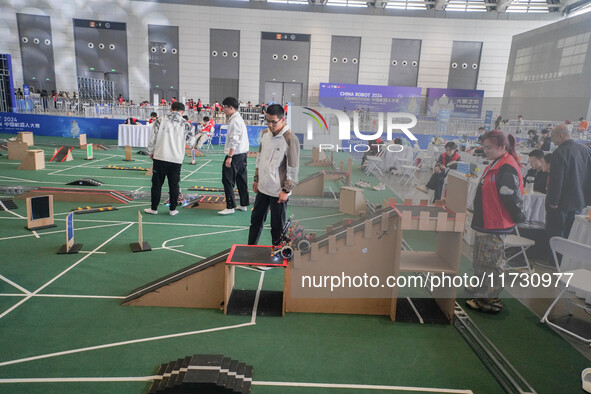 Visitors watch a robot perform at the China Robot Competition in Xi'an, China, on November 2, 2024. 