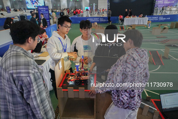 Visitors watch a robot perform at the China Robot Competition in Xi'an, China, on November 2, 2024. 