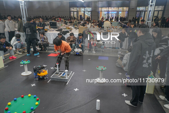 Visitors watch a robot perform at the China Robot Competition in Xi'an, China, on November 2, 2024. 