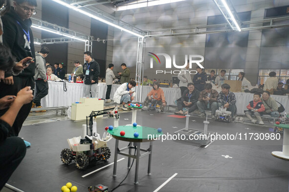 Visitors watch a robot perform at the China Robot Competition in Xi'an, China, on November 2, 2024. 