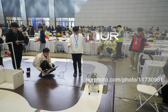 Visitors watch a robot perform at the China Robot Competition in Xi'an, China, on November 2, 2024. 