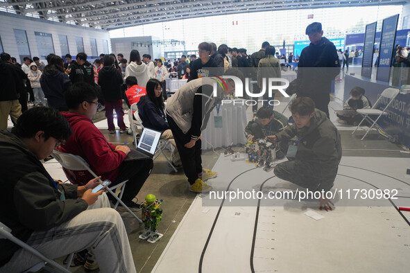 Visitors watch a robot perform at the China Robot Competition in Xi'an, China, on November 2, 2024. 