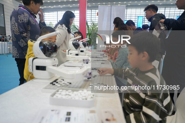 Visitors watch a robot perform at the China Robot Competition in Xi'an, China, on November 2, 2024. 