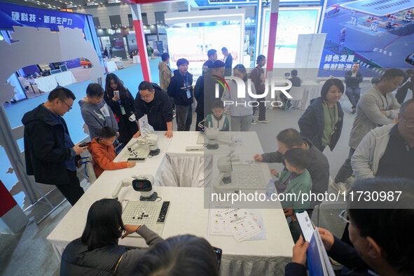 Visitors watch a robot perform at the China Robot Competition in Xi'an, China, on November 2, 2024. 