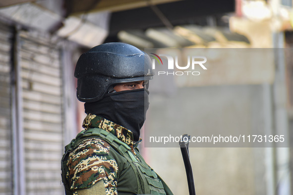 An Indian security personnel stands guard near the site of a gunbattle between suspected militants and security forces in Srinagar, Jammu an...