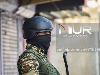 An Indian security personnel stands guard near the site of a gunbattle between suspected militants and security forces in Srinagar, Jammu an...