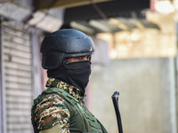 An Indian security personnel stands guard near the site of a gunbattle between suspected militants and security forces in Srinagar, Jammu an...