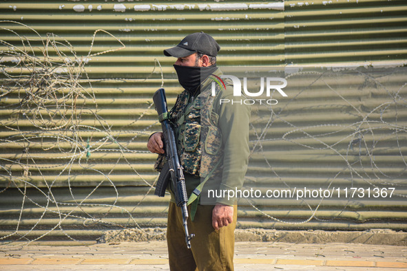 An Indian policeman stands guard near the site of a gunbattle between suspected militants and security forces in Srinagar, Jammu and Kashmir...