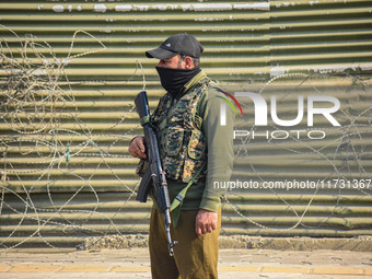 An Indian policeman stands guard near the site of a gunbattle between suspected militants and security forces in Srinagar, Jammu and Kashmir...