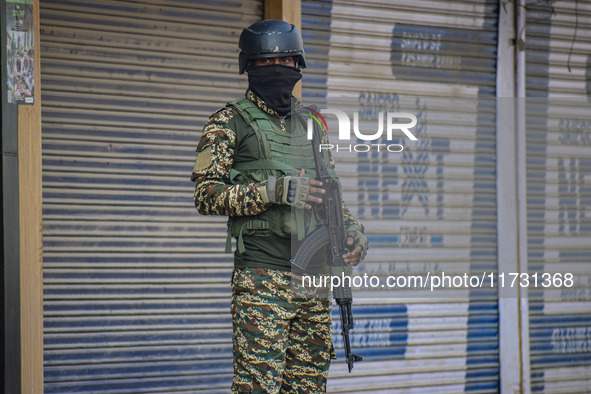 An Indian security personnel stands guard near the site of a gunbattle between suspected militants and security forces in Srinagar, Jammu an...