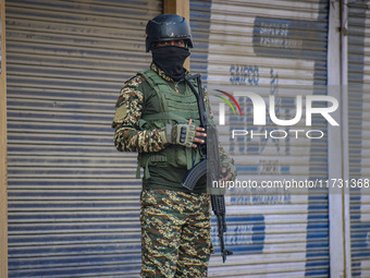 An Indian security personnel stands guard near the site of a gunbattle between suspected militants and security forces in Srinagar, Jammu an...