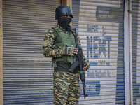 An Indian security personnel stands guard near the site of a gunbattle between suspected militants and security forces in Srinagar, Jammu an...