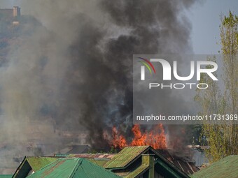 Flames and smoke billow from a residential building where militants are suspected to take refuge during a gun battle between suspected milit...