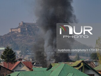 Flames and smoke billow from a residential building where militants are suspected to take refuge during a gun battle between suspected milit...