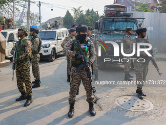 An Indian security personnel stands guard near the site of a gunbattle between suspected militants and security forces in Srinagar, Jammu an...