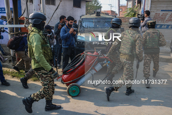 Indian security personnel move towards the site of a gun battle between suspected militants and security forces in Srinagar, Jammu and Kashm...