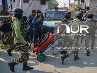 Indian security personnel move towards the site of a gun battle between suspected militants and security forces in Srinagar, Jammu and Kashm...