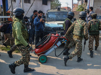 Indian security personnel move towards the site of a gun battle between suspected militants and security forces in Srinagar, Jammu and Kashm...