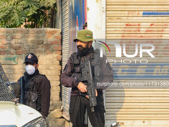 An Indian security personnel stands guard near the site of a gunbattle between suspected militants and security forces in Srinagar, Jammu an...