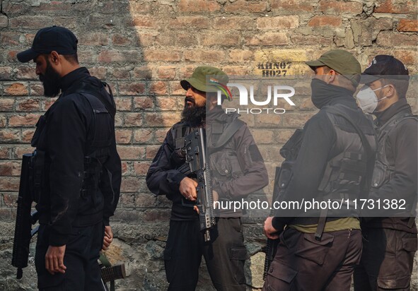 An Indian security personnel stands guard near the site of a gunbattle between suspected militants and security forces in Srinagar, Jammu an...