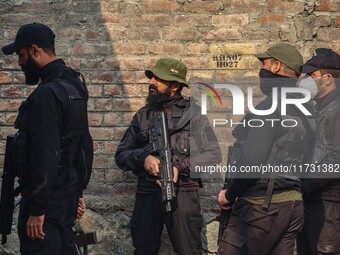 An Indian security personnel stands guard near the site of a gunbattle between suspected militants and security forces in Srinagar, Jammu an...