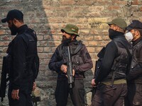 An Indian security personnel stands guard near the site of a gunbattle between suspected militants and security forces in Srinagar, Jammu an...