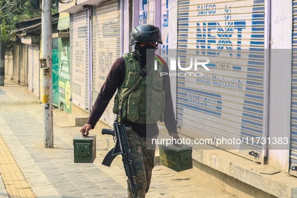 An Indian security personnel carries ammunition near the site of a gunbattle between suspected militants and security forces in Srinagar, Ja...