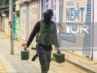 An Indian security personnel carries ammunition near the site of a gunbattle between suspected militants and security forces in Srinagar, Ja...