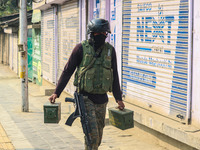 An Indian security personnel carries ammunition near the site of a gunbattle between suspected militants and security forces in Srinagar, Ja...