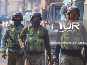 Indian security personnel walk near the site of a gunbattle between suspected militants and security forces in Srinagar, Jammu and Kashmir,...