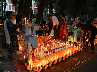 Christian devotees light candles on the graves of relatives during the celebrations of All Souls Day in a cemetery at Wari Cemetery of Holy...