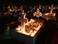 Christian devotees light candles on the graves of relatives during the celebrations of All Souls Day in a cemetery at Wari Cemetery of Holy...