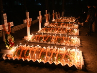 Christian devotees light candles on the graves of relatives during the celebrations of All Souls Day in a cemetery at Wari Cemetery of Holy...